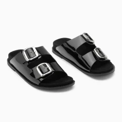 Mules plates Célia noir verni à boucles oversize